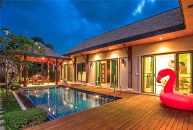 Exterior night view of a private pool at Kokyang Estate in Nai Harn Beach